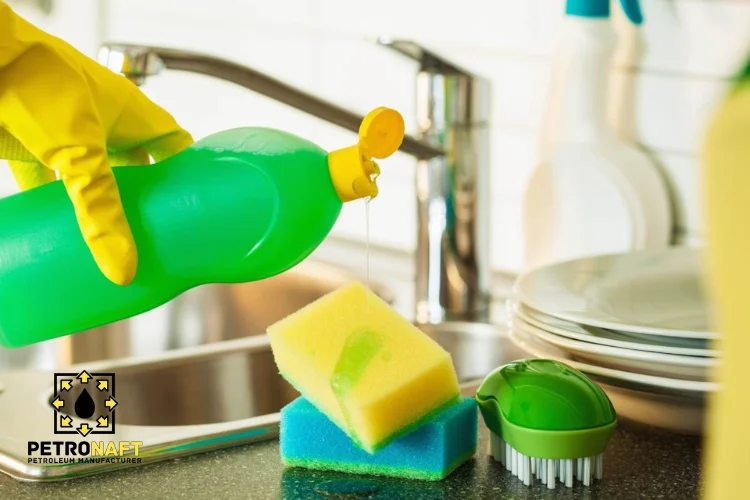 Dishwashing sink and a person using dishwashing liquid