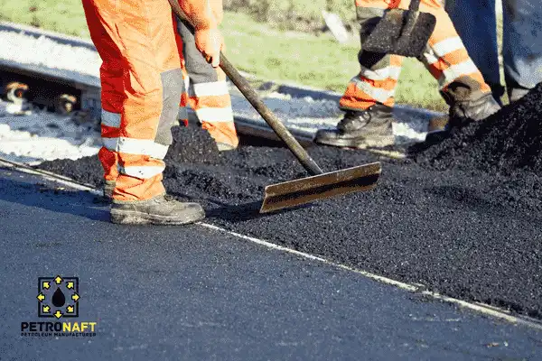 Workers repairing road pavement damage