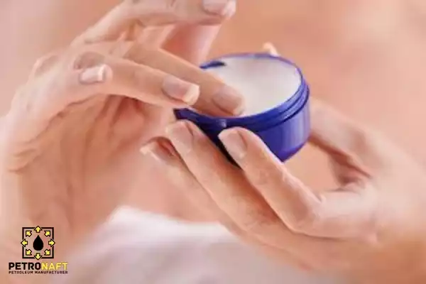 Taking some vaseline/petroleum jelly from the vaseline container for use