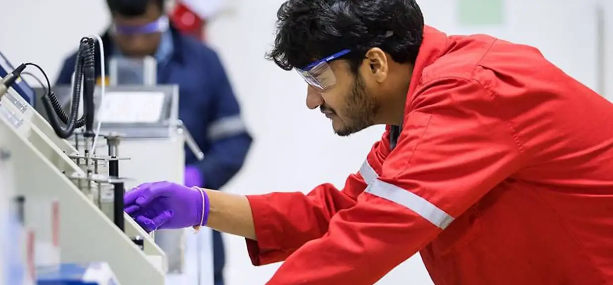 The laboratory of Petro Naft Company and one of the personnel conducting the test