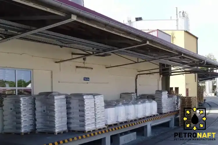 Stacked pallets of Caustic Soda bags on factory platform, ready for loading, showcasing Caustic Soda price.