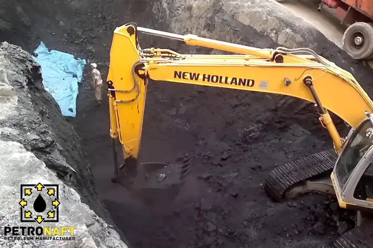 Mining operation of high-quality Gilsonite with mechanical digger at work.