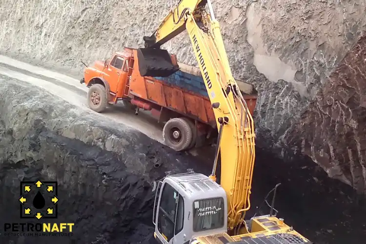 An excavator loading a truck, associated with Iran Gilsonite Manufacturers