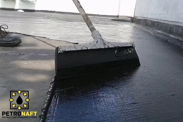 A worker insulating a roof using Oxidized Bitumen in Roofing